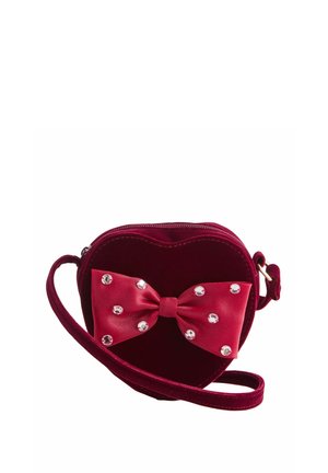 Heart-shaped purse made of burgundy velvet, featuring a satin bow and embellished with clear rhinestones. Includes a shoulder strap.