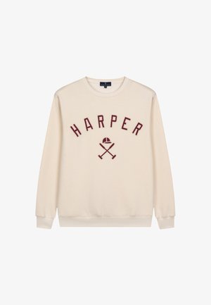 Sweatshirt crème avec le texte brodé rouge "HARPER" au-dessus de graphiques de battes croisées et d'une casquette. Texture lisse, col rond et poignets côtelés.