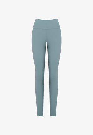 Elastyczne legginsy w przytłumionym odcieniu teal, wysoki stan, gładka faktura, pełna długość, z minimalną ilością szwów i bez widocznego metalowego wykończenia.