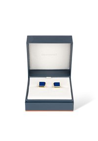 Goldfarbene Manschettenknöpfe mit quadratischer Form und tiefblauer Emaille-Einlage, präsentiert in einem navyblauen Etui mit einem weichen weißen Innenraum.