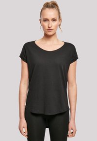 Black short-sleeve t-shirt with a wide scoop neckline, a relaxed fit, and rolled sleeve cuffs, made of a soft, lightweight fabric.