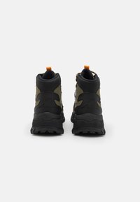 Black and olive high-top sneakers feature a rubber sole, textured panels, a pull tab, and lacing system on the back for added support.
