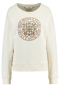 Sudadera color crema con un gráfico redondo en tonos terrosos, que presenta diseños ornamentales y texto, puños acanalados y un cuello redondo.