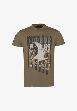 Olive green cotton t-shirt with round neck, featuring faded graphic design with text and silhouette, striped background, and shoulder badge.