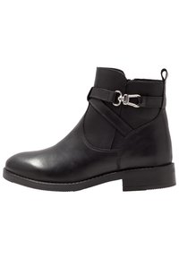 Black leather ankle boot with a rounded toe, flat rubber sole, crossed strap detail, and a side zipper for easy wear.
