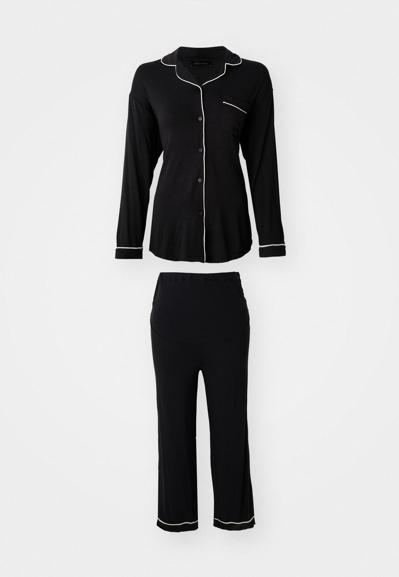 Black pajama set featuring a long-sleeve button-up top with white piping and matching pants with a relaxed fit and hem detailing.