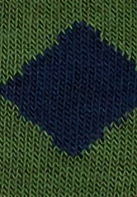Knit textile featuring a green background with a central blue diamond pattern. The texture is smooth with visible stitching details.