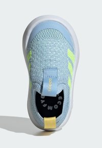 Light blue sneaker with woven upper, contrasting yellow and green accents, white sole, and pull tab featuring "adidas" branding.