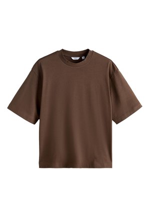 Hnedé oversized tričko s krátkym rukávom a kruhovým výstrihom s rovnými lemami na bielom pozadí.