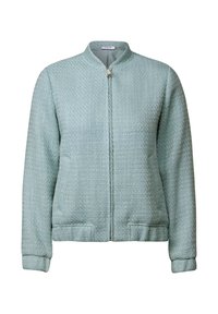 Giacca bomber verde chiaro con tessuto testurizzato, chiusura frontale con zip, colletto rialzato e polsini e orlo a coste. Due tasche laterali.