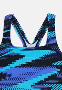 Blue and black abstract patterned Speedo swimsuit top with crossed shoulder straps and embroidered logo on chest.