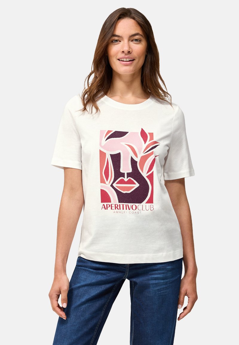 Camiseta de algodón blanca con un estampado gráfico de rostros abstractos y hojas en tonos rojos y rosas, con el texto "APERITIVO CLUB AMALFI COAST".