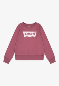 Felpa rosa con collo tondo e maniche lunghe a raglan. Caratterizzata da un logo bianco di Levi's al centro e polsini e orlo a costine.
