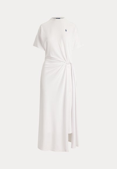 White midi dress with short sleeves, high neckline, side knot detail, and small dark logo on the chest.
