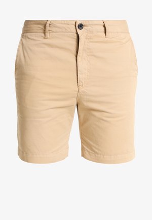 Beige katoenen korte broek met een ritssluiting en knoopsluiting, voorzien van zijzakken en een gladde textuur. Afgewerkt op kniehoogte.