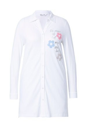 Camisa blanca de botonadura con mangas largas. Presenta diseños florales en rosa, azul y gris, y el texto "Haz más de lo que te hace feliz".