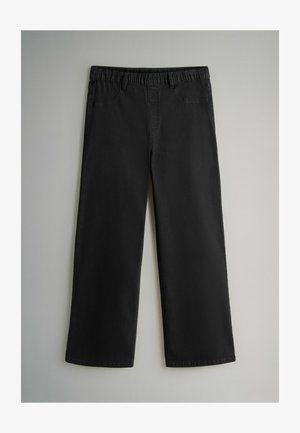 Zwarte, wijde broek met een elastische tailleband, twee voorzakken en een gladde textuur. Gemaakt van een duurzame stof, geschikt voor casual kleding.