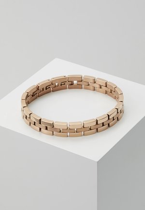 Gold-toned metal bracelet with rectangular links arranged in a double row, displayed on a white pedestal against a light gray background.