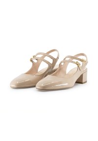 Scarpe slingback in pelle verniciata beige con due cinturini regolabili, punta appuntita e tacco a blocco basso. Texture liscia con accenti in hardware dorato.