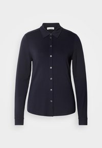 Chemise noire à manches longues avec col, coupe slim et sept boutons devant, présentée sur fond blanc.