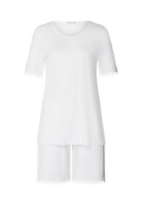 Conjunto de loungewear de algodón blanco que incluye una camiseta de manga corta con dobladillo con forma de concha y pantalones cortos a juego con bordes de concha. Textura suave.