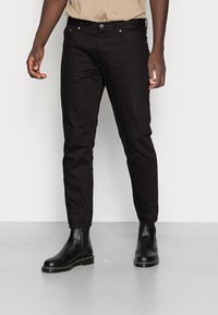 Slim-fit black jeans with a classic five-pocket design, made from denim. Features a smooth texture and subtle stitching details.