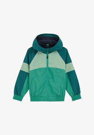 Zelena jakna s kapuljačom, izrađena od više nijansi zelene boje, s elastičnim rukavima i prednjim zatvaračem. Glatkava, lagana tkanina.