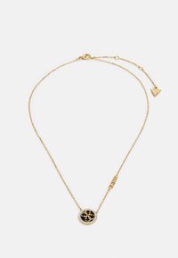 Collana in oro con ciondolo nero rotondo, circondato da pietre trasparenti, con dettaglio del logo e lunghezza regolabile.