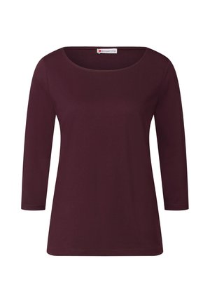 Camiseta de manga larga burdeos con cuello redondo, textura suave y corte relajado, con una etiqueta cosida en la parte posterior.