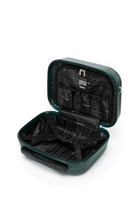 Custodia da viaggio rigida verde con chiusura a zip, dotata di interno a righe nere, tasche organizzate e cinghie stampate per un'immagazzinamento sicuro.