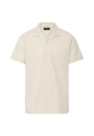 Chemise beige à manches courtes avec col ouvert et boutons sur le devant, confectionnée en tissu léger.