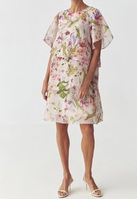 Robe à imprimé floral avec des manches courtes flottantes, design superposé, dans des teintes de rose clair, présentant des motifs de fleurs vertes et colorées.