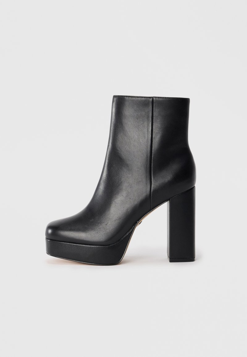 Black leather ankle boot with a high square heel and platform front. The design is sleek with a smooth texture and minimalistic style.