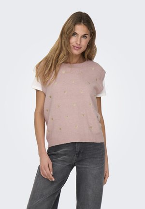Pink knitted sweater with gold heart patterns, layered over a white shirt. Features short sleeves and a relaxed fit.