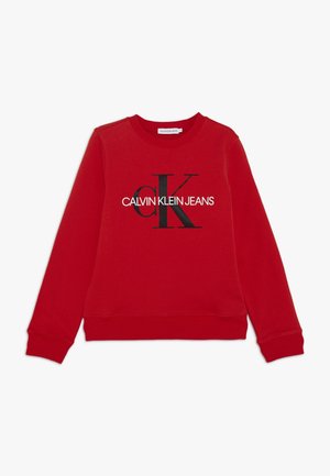 Rød langærmet sweatshirt med rund hals og sort-hvidt "CALVIN KLEIN JEANS" logo centreret på brystet.