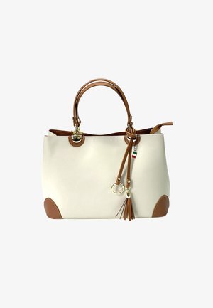 Beige tote bag met bruine accenten, handvatten bovenop en een afneembare franjer. Gemaakt van glad materiaal met ronde hoeken en gouden details.