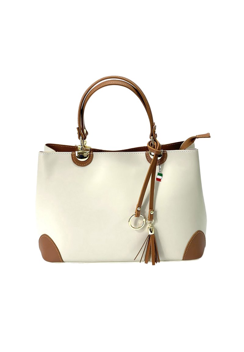 Beige tote bag met bruine accenten, handvatten bovenop en een afneembare franjer. Gemaakt van glad materiaal met ronde hoeken en gouden details.