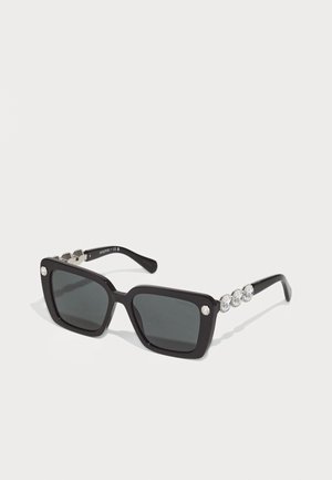 Schwarze quadratische Sonnenbrille mit grauen Gläsern, ausgestattet mit drei klaren Strasssteinen an jedem Bügel und silbernen Hardware-Akzenten.