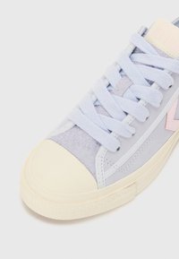 Light blue suede sneaker with cream rubber toe cap and sole. Features pastel pink accents and flat laces. Textured upper detail visible.