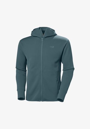 Capuchon met ritssluiting in donker turkoois. Gemaakt van textiel met een textuur, voorzien van twee voorzakken en aansluitende manchetten. Subtiel logo nabij de rits.