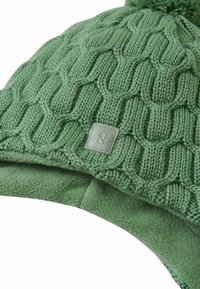 Green knit hat with a textured pattern, featuring a soft fleece lining and a small stitched logo label in the front. Includes a pom-pom on top.