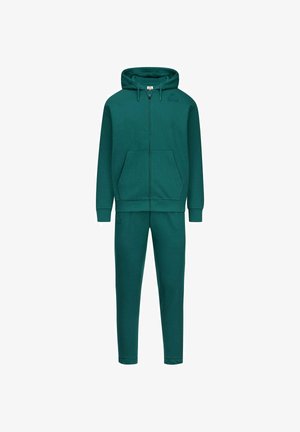 Felpa con cappuccio e zip turchese con tasche a marsupio e pantaloni jogger abbinati a gamba stretta. Realizzati in tessuto morbido, con finitura senza cuciture e branding minimale.