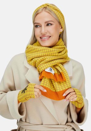 Yellow and orange houndstooth-patterned scarf and matching fingerless gloves, made of soft, textured fabric with knit detailing.