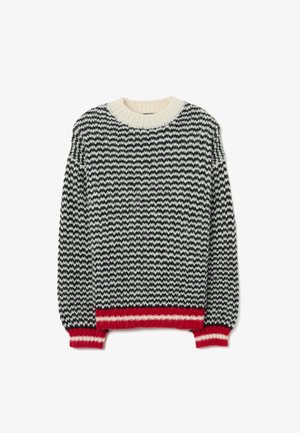 Suéter de punto con un patrón de zigzag en blanco y negro, cuello crema y borde inferior y puños acanalados en rojo. Textura suave, ajuste holgado.
