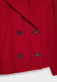 Red wool coat with double-breasted black buttons, wide lapels, and vertical slit pockets on each side.