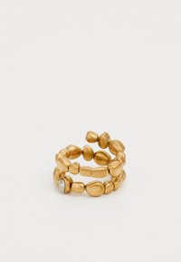 Gold-tone metal ring featuring a textured, irregular shape with a smooth surface and one diamond-like accent; flexible design with stacked elements.