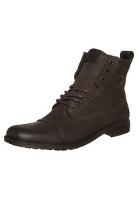 Bottines en cuir marron avec un bout rond, un laçage à l'avant et deux œillets métalliques. Le design présente une finition légèrement texturée et un talon bas.