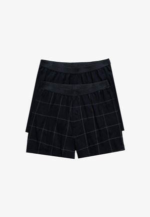 Czarne bawełniane bokserki w kratę, z elastycznym pasem i jednym guzikiem z przodu. Miękka tekstura i swobodny fason.