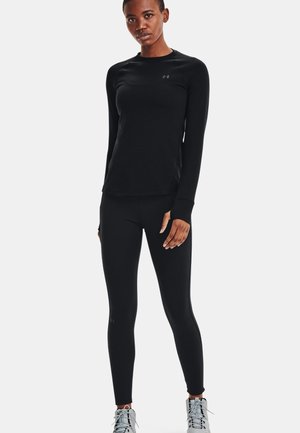 Schwarzes langärmeliges Sportshirt und eng anliegende Leggings aus leichtem Stoff, mit einer glatten Textur und dezentem Logo-Detail.