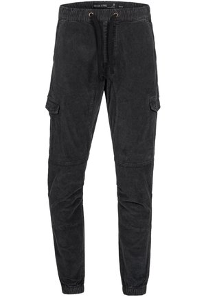 Dark grey cargo pants made of textured fabric. Features elastic waistband with drawstring, side pockets, and gathered ankles.